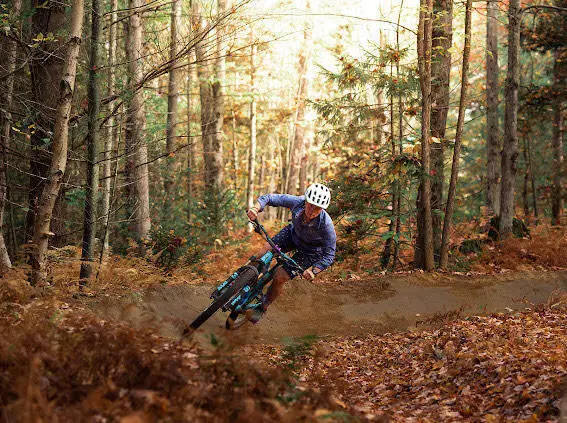 Michy Lemay rides though the woods.